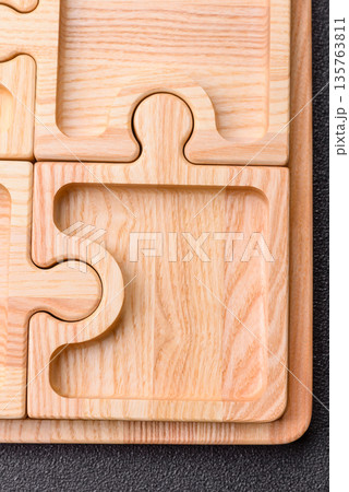 Wooden empty puzzle serving tray, kitchen accessories. A wooden empty puzzle tray 135763811