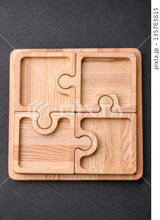 Wooden empty puzzle serving tray, kitchen accessories. A wooden empty puzzle tray 135763815
