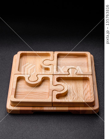 Wooden empty puzzle serving tray, kitchen accessories. A wooden empty puzzle tray Wooden empty puzzle serving tray, kitchen accessories. A wooden empty puzzle tray 135763816