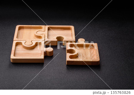 Wooden empty puzzle serving tray, kitchen accessories. A wooden empty puzzle tray 135763826