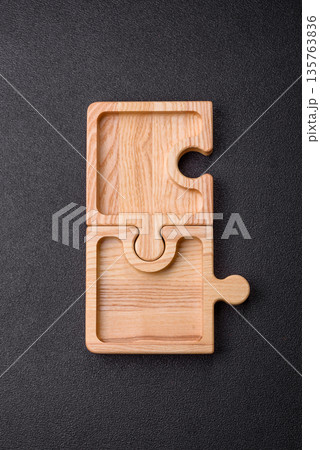Wooden empty puzzle serving tray, kitchen accessories. A wooden empty puzzle tray 135763836