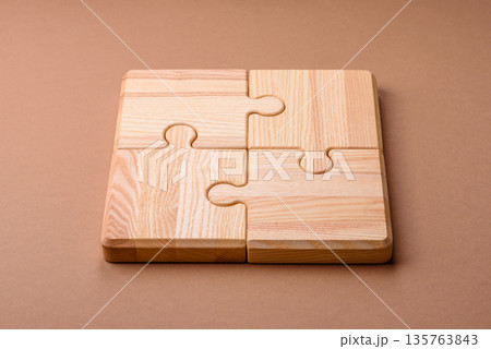 A wooden empty puzzle piece for a sign or business concept. A wooden empty puzzle 135763843