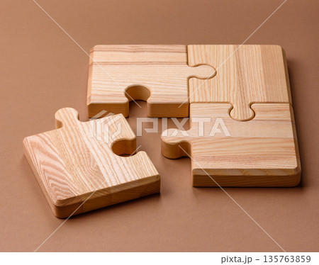 A wooden empty puzzle piece for a sign or business concept. A wooden empty puzzle A wooden empty puzzle piece for a sign or business concept. A wooden empty puzzle 135763859