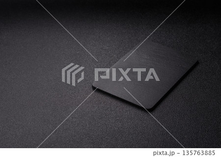A black slate stone board or plate, an empty kitchen utensil. A black slate board A black slate stone board or plate, an empty kitchen utensil. A black slate board 135763885