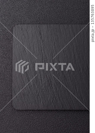 A black slate stone board or plate, an empty kitchen utensil. A black slate board 135763895