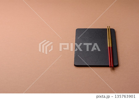 A black slate stone board or plate, an empty kitchen utensil. A black slate board A black slate stone board or plate, an empty kitchen utensil. A black slate board 135763901