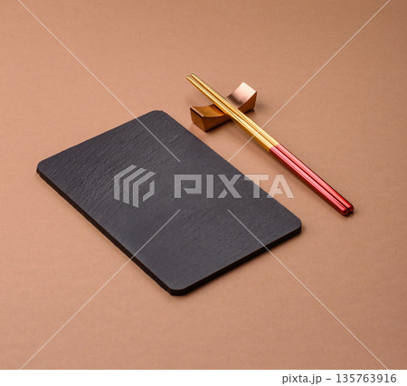 A black slate stone board or plate, an empty kitchen utensil. A black slate board 135763916
