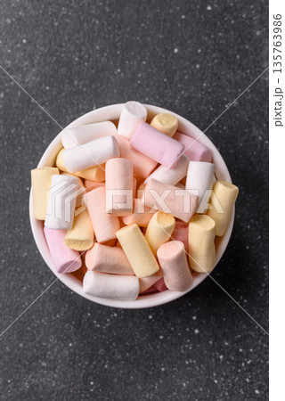 Mini marshmallows in white, pink, and pastel colors. Marshmallows as a food background Mini marshmallows in white, pink, and pastel colors. Marshmallows as a food background 135763986
