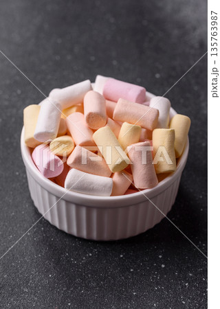 Mini marshmallows in white, pink, and pastel colors. Marshmallows as a food background Mini marshmallows in white, pink, and pastel colors. Marshmallows as a food background 135763987