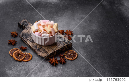 Mini marshmallows in white, pink, and pastel colors. Marshmallows as a food background Mini marshmallows in white, pink, and pastel colors. Marshmallows as a food background 135763992