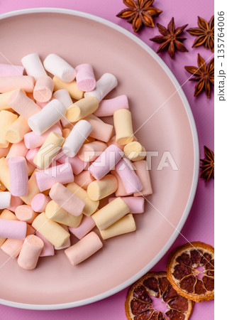 Mini marshmallows in white, pink, and pastel colors. Marshmallows as a food background 135764006