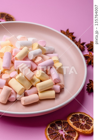 Mini marshmallows in white, pink, and pastel colors. Marshmallows as a food background Mini marshmallows in white, pink, and pastel colors. Marshmallows as a food background 135764007