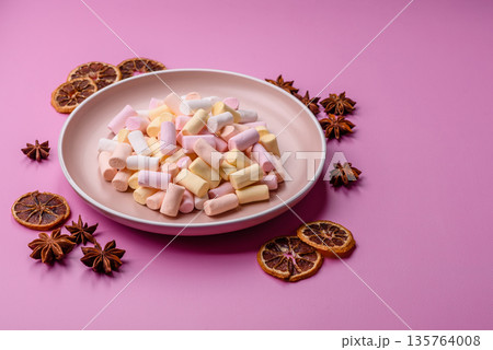 Mini marshmallows in white, pink, and pastel colors. Marshmallows as a food background 135764008
