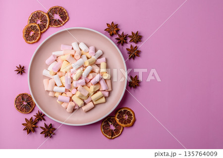 Mini marshmallows in white, pink, and pastel colors. Marshmallows as a food background 135764009