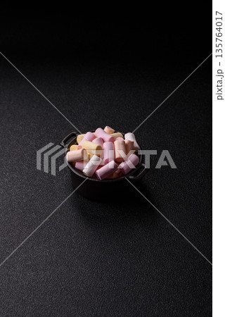 Mini marshmallows in white, pink, and pastel colors. Marshmallows as a food background Mini marshmallows in white, pink, and pastel colors. Marshmallows as a food background 135764017