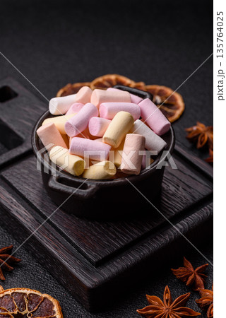Mini marshmallows in white, pink, and pastel colors. Marshmallows as a food background 135764025