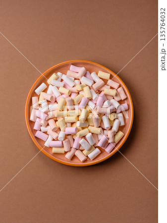 Mini marshmallows in white, pink, and pastel colors. Marshmallows as a food background Mini marshmallows in white, pink, and pastel colors. Marshmallows as a food background 135764032