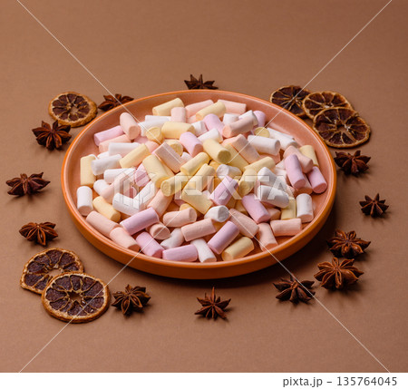 Mini marshmallows in white, pink, and pastel colors. Marshmallows as a food background 135764045
