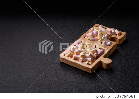 Mini marshmallows in white, pink, and pastel colors. Marshmallows as a food background Mini marshmallows in white, pink, and pastel colors. Marshmallows as a food background 135764061