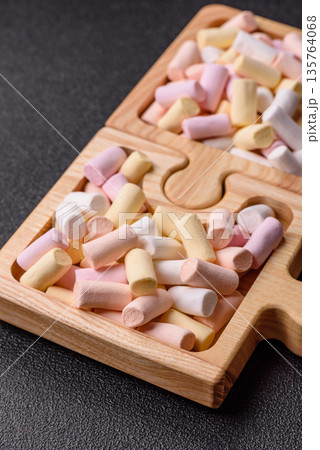 Mini marshmallows in white, pink, and pastel colors. Marshmallows as a food background 135764068