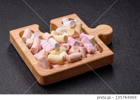 Mini marshmallows in white, pink, and pastel colors. Marshmallows as a food background 135764069