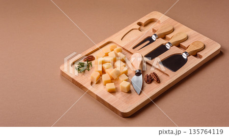 Cubed cheddar, gouda, or parmesan cheese on a cutting board. Cubed cheese Cubed cheddar, gouda, or parmesan cheese on a cutting board. Cubed cheese 135764119