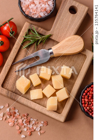 Cubed cheddar, gouda, or parmesan cheese on a cutting board. Cubed cheese Cubed cheddar, gouda, or parmesan cheese on a cutting board. Cubed cheese 135764141