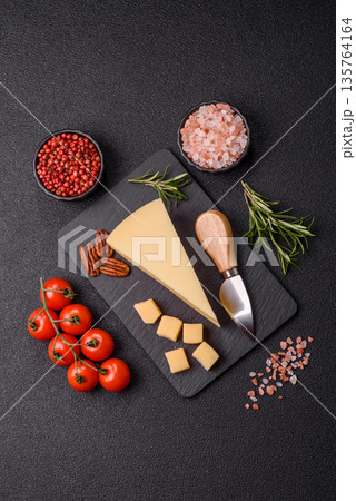 A wedge of cheddar, gouda, or parmesan cheese on a cutting board. Cheese wedge A wedge of cheddar, gouda, or parmesan cheese on a cutting board. Cheese wedge 135764164
