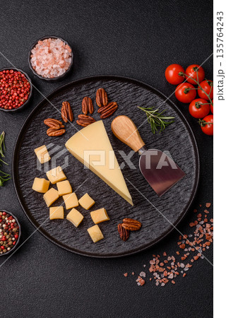 A wedge of cheddar, gouda, or parmesan cheese on a cutting board. Cheese wedge A wedge of cheddar, gouda, or parmesan cheese on a cutting board. Cheese wedge 135764243