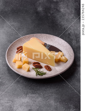 A wedge of cheddar, gouda, or parmesan cheese on a cutting board. Cheese wedge A wedge of cheddar, gouda, or parmesan cheese on a cutting board. Cheese wedge 135764248