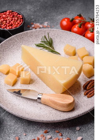 A wedge of cheddar, gouda, or parmesan cheese on a cutting board. Cheese wedge A wedge of cheddar, gouda, or parmesan cheese on a cutting board. Cheese wedge 135764253