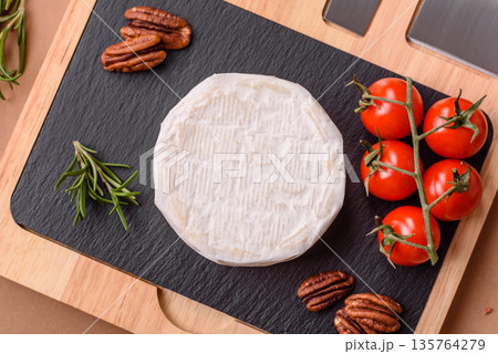 White French cream cheese Brie or Camembert for breakfast. Brie or Camembert cheese 135764279