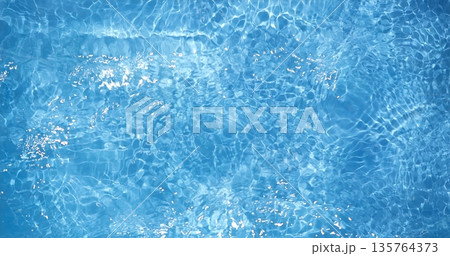 Glistening Blue Water, Bright Sunlight Causes Shimmering Patterns On Gentle Moving Water Of Backyard Pool 135764373