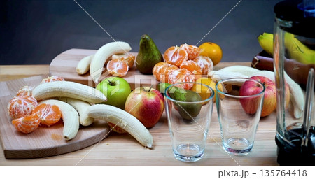 Fruits On Wooden Table, Colorful Fruit Arrangement With Beverages, Fresh Produce And Drinks Set For Breakfast Fruits On Wooden Table, Colorful Fruit Arrangement With Beverages, Fresh Produce And Drinks Set For Breakfast 135764418