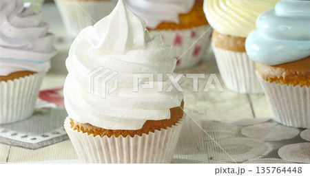 Beautifully Decorated Vanilla Cupcake With Smooth Frosting On Vintage Linen In Soft Daylight 135764448