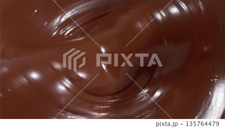 Closeup Of Luscious Dark Chocolate Swirl, Indulgent Melted Dark Chocolate With Glossy Finish Detail 135764479