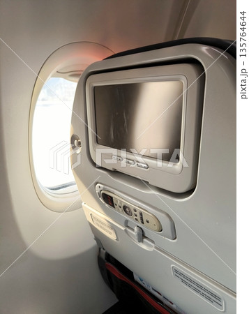 View from inside the airplane cabin of the window and seat View from inside the airplane cabin of the window and seat 135764644
