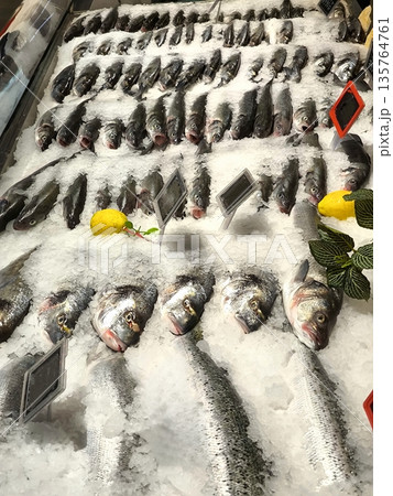 Fresh fish on an ice display at a fish store Fresh fish on an ice display at a fish store 135764761