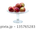 Ripe garden apples in a transparent fruit bowl. Isolated object for healthy eating, diet, harvest, and cozy kitchen interior themes. 135765283