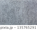Macro shot of a soft textile surface with pile. Neutral gray background for design showing a cozy texture of fabric, carpet, or blanket 135765291