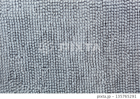 Macro shot of a soft textile surface with pile. Neutral gray background for design showing a cozy texture of fabric, carpet, or blanket 135765291