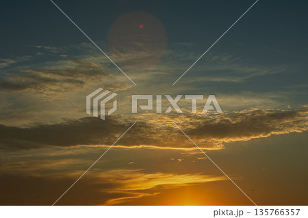 Soft golden sunset clouds over Vlora, Albania on August 2025, with a lone bird gliding across the sky in a peaceful minimalistic scene. Soft golden sunset clouds over Vlora, Albania on August 2025, with a lone bird gliding across the sky in a peaceful minimalistic scene. 135766357