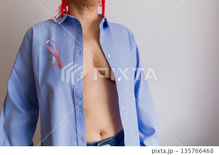 Woman wearing pink ribbon for breast cancer awareness Woman wearing pink ribbon for breast cancer awareness 135766468