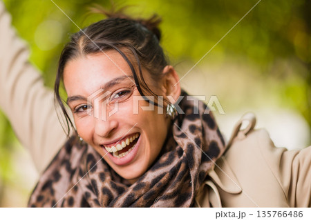 Young hispanic woman smiling broadly with joy 135766486