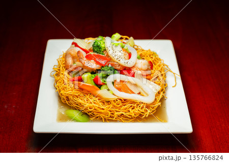 Seafood Stir-Fry on Crispy Noodle Basket Seafood Stir-Fry on Crispy Noodle Basket 135766824