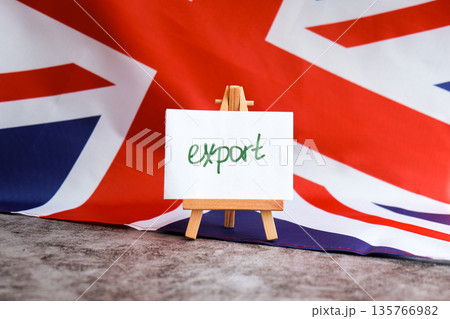 Paper note with words EXPORT on National symbol of Great Britain. British wave the UK silky flag background. Concept of economy industry global market international shipping 135766982