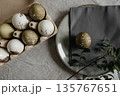 Easter holiday. Painted olive-colored eggs on a linen tablecloth. Easter decoration. 135767651