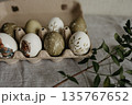 Easter holiday. Painted olive-colored eggs on a linen tablecloth. Easter decoration. 135767652