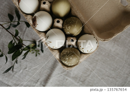 Easter holiday. Painted olive-colored eggs on a linen tablecloth. Easter decoration. Easter holiday. Painted olive-colored eggs on a linen tablecloth. Easter decoration. 135767654