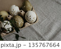 Easter holiday. Painted olive-colored eggs on a linen tablecloth. Easter decoration. 135767664